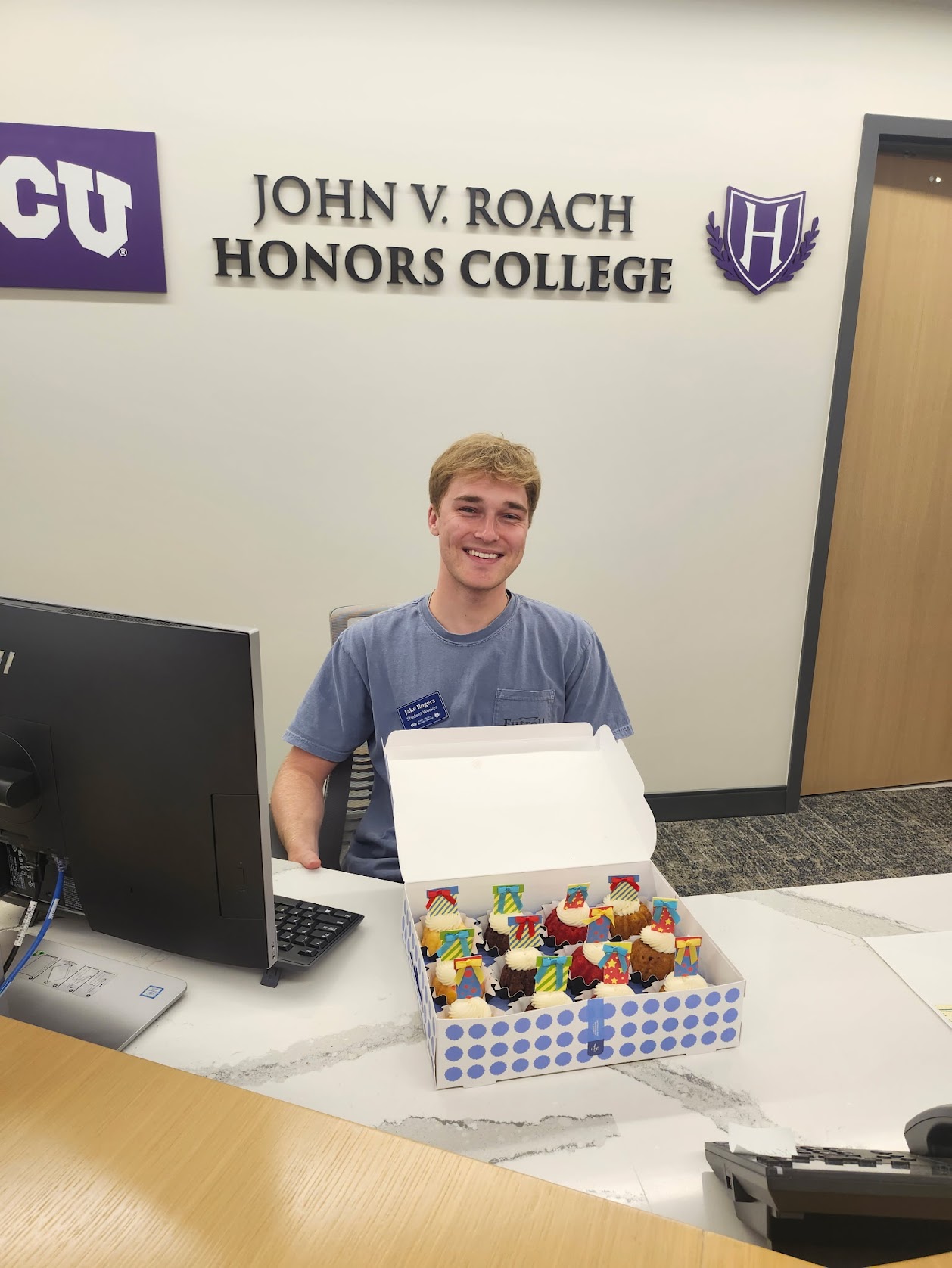Jake Rogers at the Roach Honors front desk Jake Rogers sitting at the Roach Honors front desk
